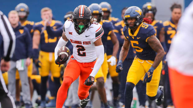 Oct 21, 2023; Morgantown, West Virginia, USA; Oklahoma State Cowboys cornerback Korie Black (2) intercepts a pass and runs for extra yards during the first quarter against the West Virginia Mountaineers at Mountaineer Field at Milan Puskar Stadium. Mandatory Credit: Ben Queen-USA TODAY Sports